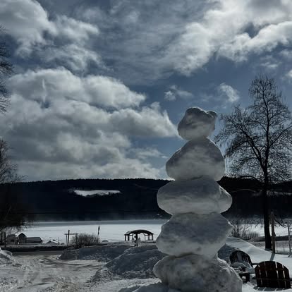 Snowman by Lake